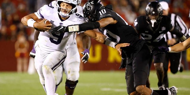 Quarterback Adrian Martinez (9) of the Kansas State Wildcats is tackled by defensive back Darien Porter (10) of the Iowa State Cyclones as he scrambles for yards in the second half at Jack Trice Stadium Oct. 8, 2022, in Ames, Iowa. The Wildcats won 10-9. 