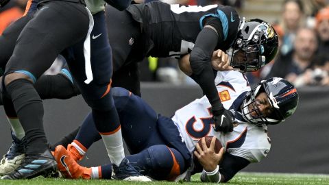 Wilson is sacked by Jacksonville's Arden Key during the first quarter at Wembley Stadium.