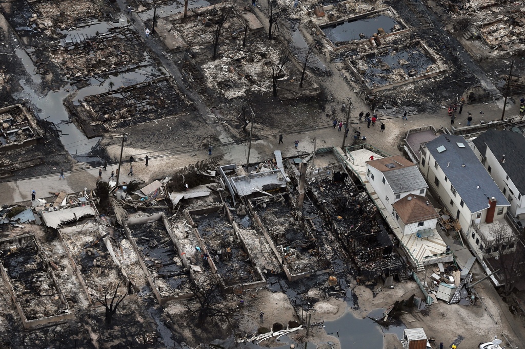 Breezy Point residents walk through the remains of homes after Superstorm Sandy on Oct. 31, 2012.