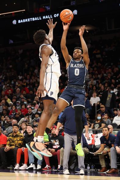 Bronny James #0 of the Sierra Canyon Trailblazers attempts a three-point shot over Ben Egbo #9 of the Perry Pumas during the Hoophall West tournament at Footprint Center on Dec. 11, 2021 in Phoenix, Arizona.