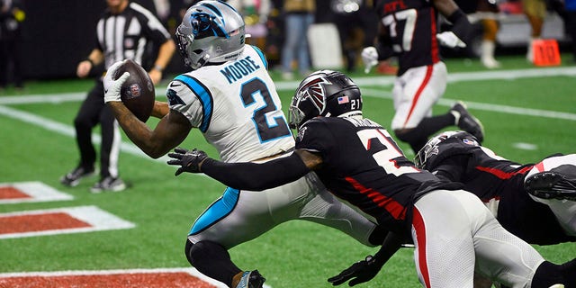 Carolina Panthers wide receiver DJ Moore (2) catches a touchdown pass as Atlanta Falcons safety Dean Marlowe (21) defends during the second half of an NFL football game Sunday, Oct. 30, 2022, in Atlanta.