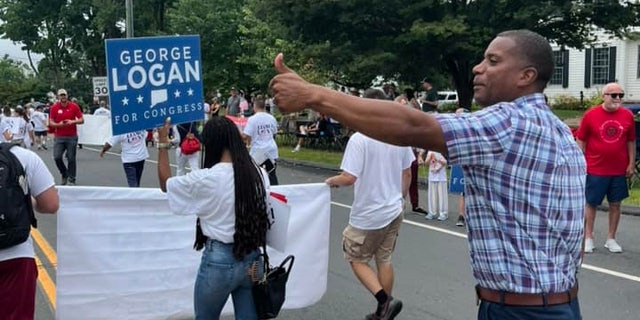 Republican Congressional nominee George Logan marches in a parade in Newtown, Connecticut, on Sept. 5, 2022 