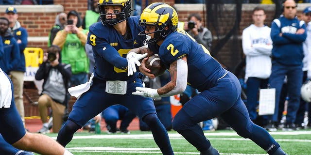 J.J. McCarthy (9) hands the ball off to Blake Corum (2) of the Michigan Wolverines during the first half of a game against the Penn State Nittany Lions at Michigan Stadium Oct. 15, 2022, in Ann Arbor, Mich. 