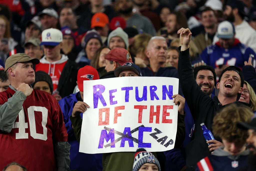 A fan holds up an updated sign, showing support for QB Bailey Zappe over Mac Jones, Monday night.