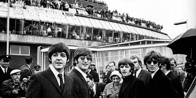 Photo of the Beatles — left to right, Paul McCartney, John Lennon, Ringo Starr and George Harrison — as they left Heathrow Airport for a final tour of the USA with cheering crowds seen everywhere. 