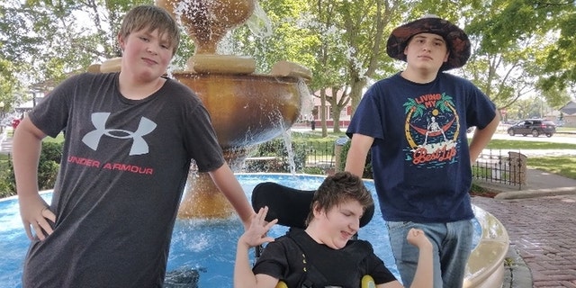 Three of the four Suriano brothers pose for a photo.