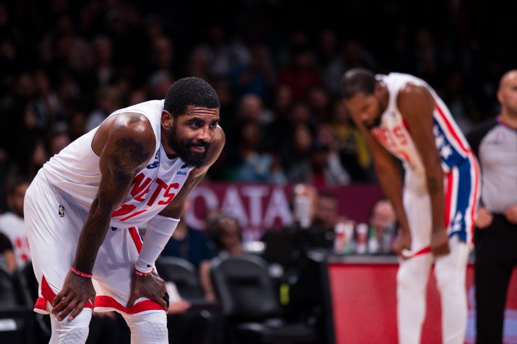 A tired Kyrie Irving and Kevin Durant (back) take a breather during the Nets' 125-116 loss to the Pacers.