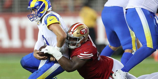 Los Angeles Rams quarterback Matthew Stafford, left, is sacked by San Francisco 49ers defensive tackle Hassan Ridgeway during the second half of an NFL football game in Santa Clara, Calif., Monday, Oct. 3, 2022.