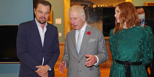 King Charles, former Prince of Wales, speaks with Leonardo DiCaprio as he views a fashion installation by designer Stella McCartney, at the Kelvingrove Art Gallery and Museum, during the Cop26 summit being held at the Scottish Event Campus on Nov. 3, 2021 in Glasgow, Scotland.