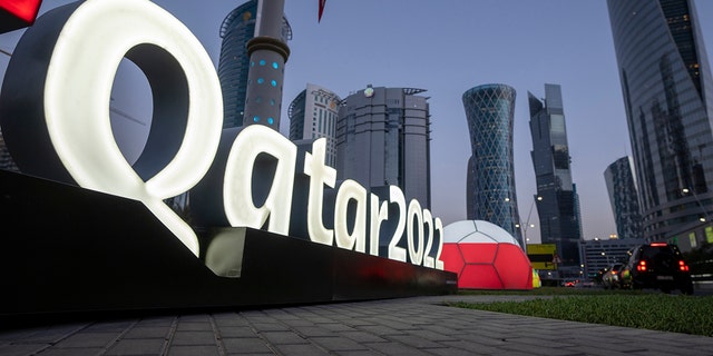 Branding is displayed near the Doha Exhibition and Convention Center where soccer's World Cup draw will be held, in Doha, Qatar, Thursday, March 31, 2022. The final draw will be held on April 1.