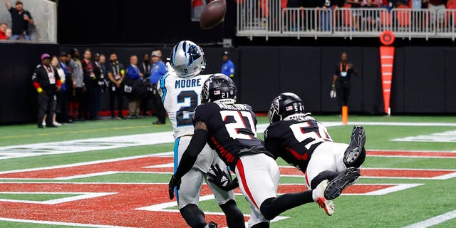 DJ Moore #2 of the Carolina Panthers catches a touchdown pass against Dean Marlowe #21 of the Atlanta Falcons and Rashaan Evans #54 of the Atlanta Falcons during the fourth quarter at Mercedes-Benz Stadium on Oct. 30, 2022 in Atlanta, Georgia.