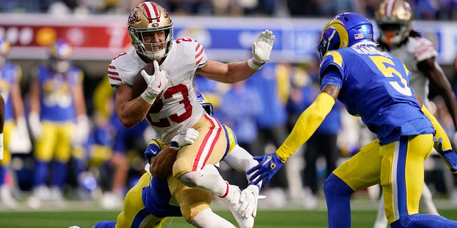 San Francisco 49ers running back Christian McCaffrey, center, stiff-arms Los Angeles Rams cornerback Jalen Ramsey, right, during the first half, Oct. 30, 2022, in Inglewood, California.