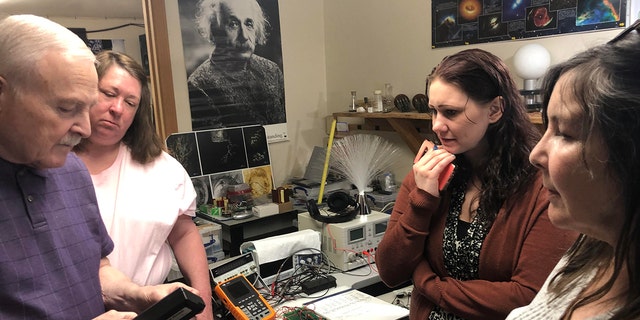 PI-NE team members are shown in a lab working on one of their cases. 