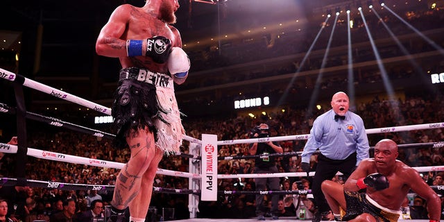 Jake Paul (L) reacts after knocking down Anderson Silva of Brazil during their cruiserweight bout at Gila River Arena on October 29, 2022 in Glendale, Arizona. 