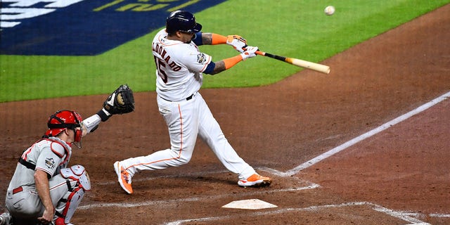 Martin Maldonado (15) of the Houston Astros hits an RBI single in the second inning during Game 1 of the 2022 World Series against the Philadelphia Phillies at Minute Maid Park Friday, Oct. 28, 2022, in Houston. 