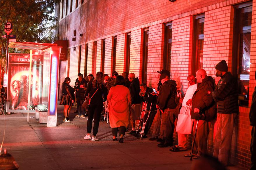 People standing outside of hotel after fire