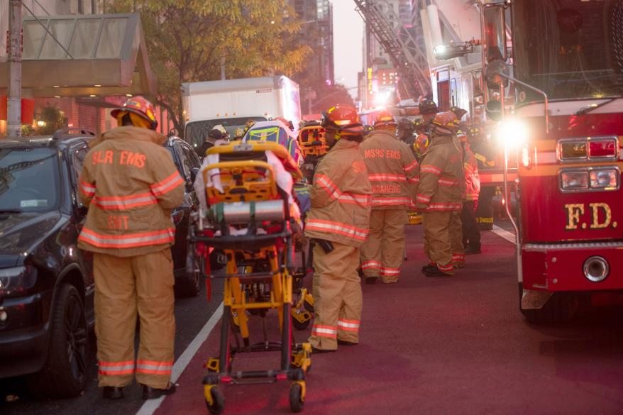 multiple FDNY firefighters around a stretcher