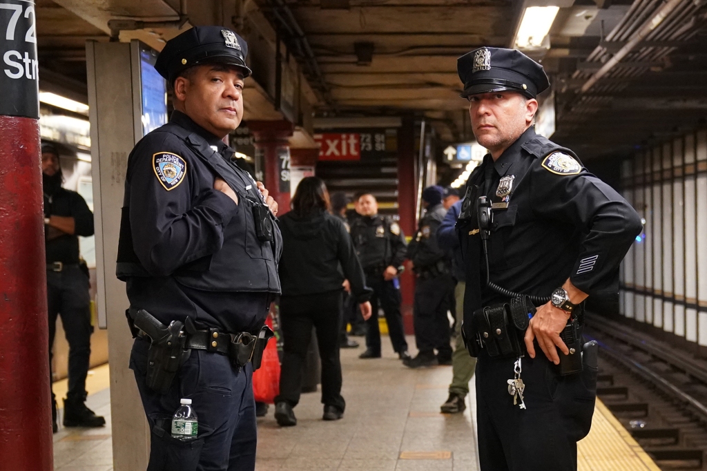 NYPD police officers patrol city subways.