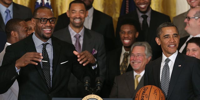 Miami Heat player LeBron James, left, speaks to President Barack Obama during an event to honor the NBA champion Miami Heat in the East Room at the White House in Washington, D.C., on Jan. 28, 2013.