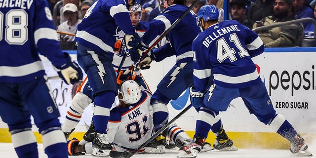 The skate of Pat Maroon #14 of the Tampa Bay Lightning cuts the arm of Evander Kane #91 of the Edmonton Oilers during the second period at Amalie Arena on November 8, 2022 in Tampa, Florida.