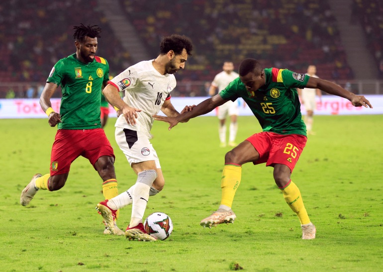 Egypt's Mohamed Salah in action with Cameroon's Andre-Frank Zambo Anguissa and Nouhou Tolo