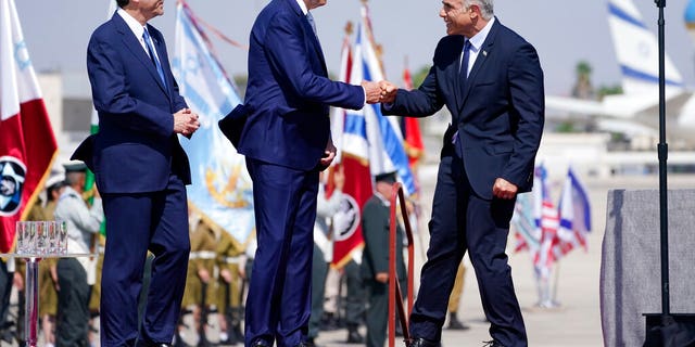 President Biden is greeted by Israeli Prime Minister Yair Lapid, and President Isaac Herzog, left, as during Biden's visit to Israel in July 2022.