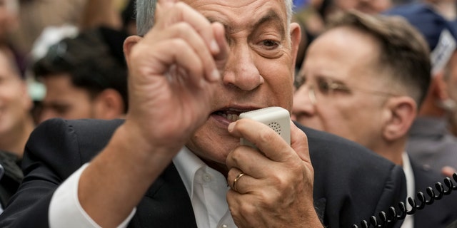Likud Party head and former Israeli Prime Minister Benjamin Netanyahu speaks to his supporters as he visits at Hatikva Market in Tel Aviv, Israel, Friday, Oct. 28, 2022, during his campaign ahead of the country's election. Israel is heading into its fifth election in under four years on Nov. 1, 2022. 