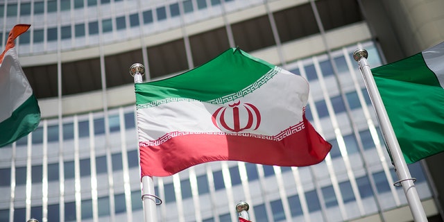 FILE: The flag of Iran is seen in front of the building of the International Atomic Energy Agency (IAEA) Headquarters ahead of a press conference by Rafael Grossi, Director General of the IAEA, about the agency's monitoring of Iran's nuclear energy program on May 24, 2021, in Vienna, Austria. 