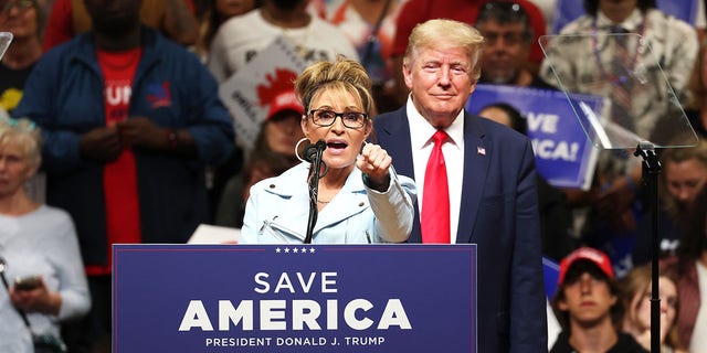 Former Alaska Gov. Sarah Palin speaks as former U.S. President Donald Trump looks on during a "Save America" rally at Alaska Airlines Center on July 09, 2022 in Anchorage, Alaska.