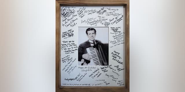 Guests who attended Harold Chilton's 100th birthday party signed a portrait. The photo from years ago shows him playing the accordion. Among the comments to him: "Thank you for being my hero since I was little" and "thank you for a lifetime of inspiration."