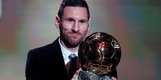 Barcelona's soccer player Lionel Messi holds the trophy of the Golden Ball award ceremony in Paris, Monday, Dec. 2, 2019. Messi won the Ballon d'Or for sixth time. 