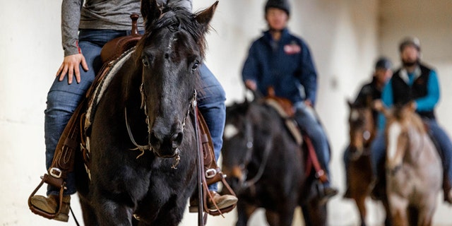 A group of veterans practices their horsemanship during the all-veteran drill team.