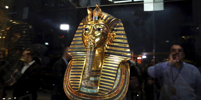 The golden mask of King Tutankhamun is displayed inside a glass cabinet at the Egyptian Museum in Cairo, Egypt, Dec. 16, 2015.